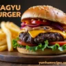 A delicious Wagyu burger with cheese, lettuce, and tomato on a brioche bun, accompanied by crispy fries.