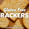 Assortment of gluten free crackers on a wooden board with a bowl of dip, perfect for healthy snacking.